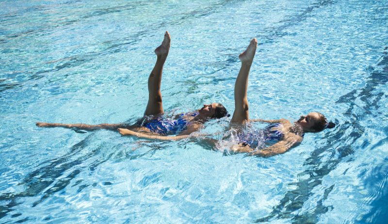 pretty-young-girl-enjoying-swimming-together